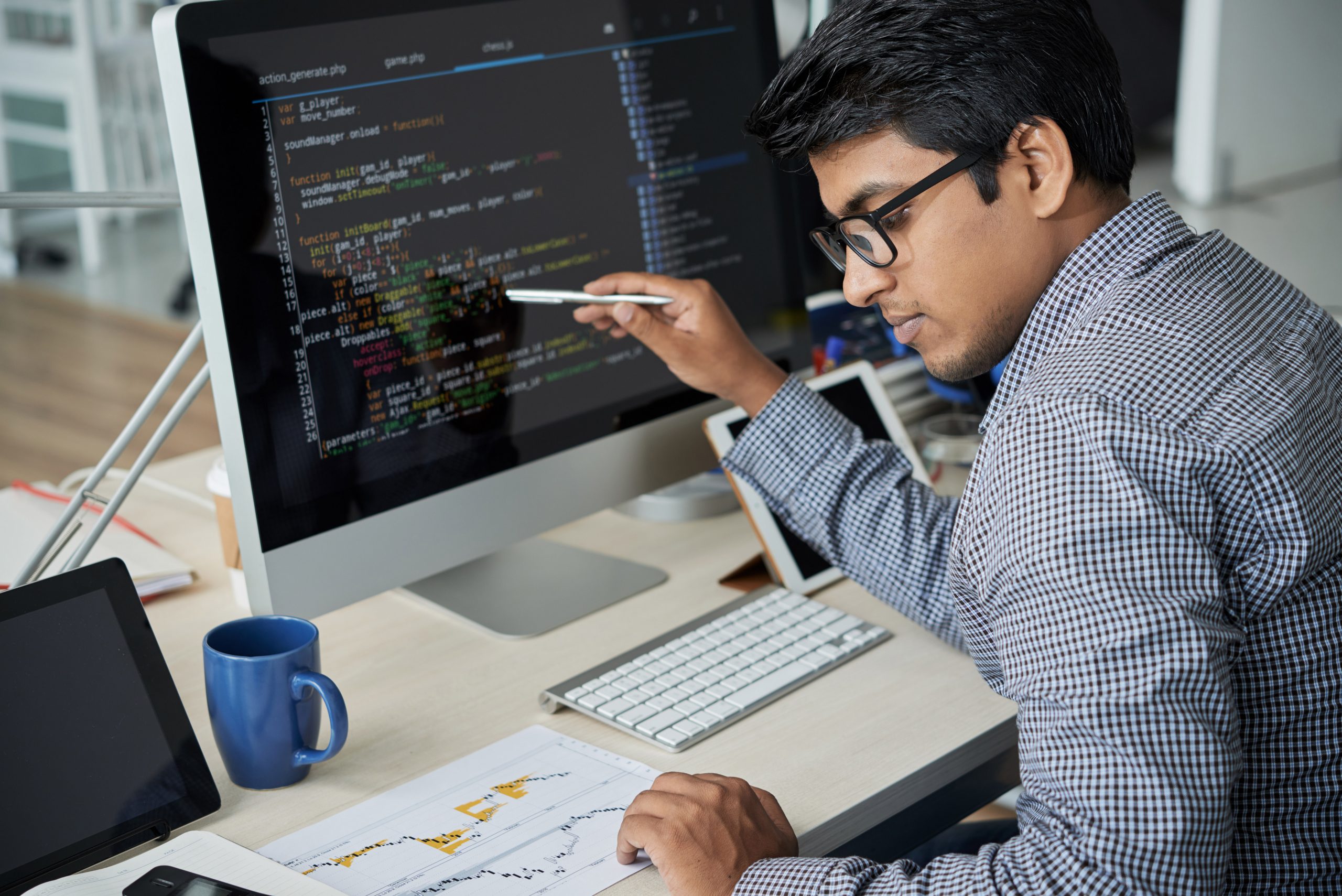 indian tech employee checking a software code