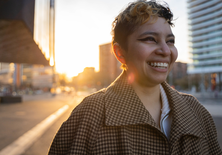 woman smiling while looking at a distance