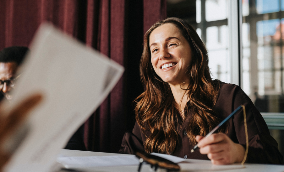 Smiling business woman discussing with colleague during meeting