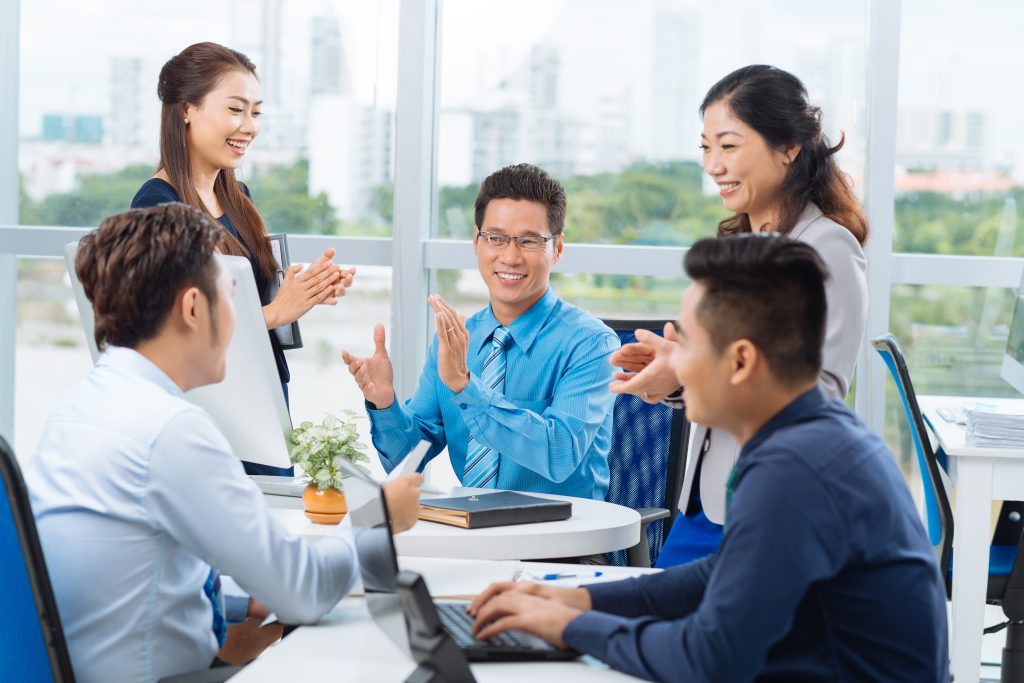 Cheerful,Vietnamese,Business,Team,Applauding Meeting taking place at Western Union
